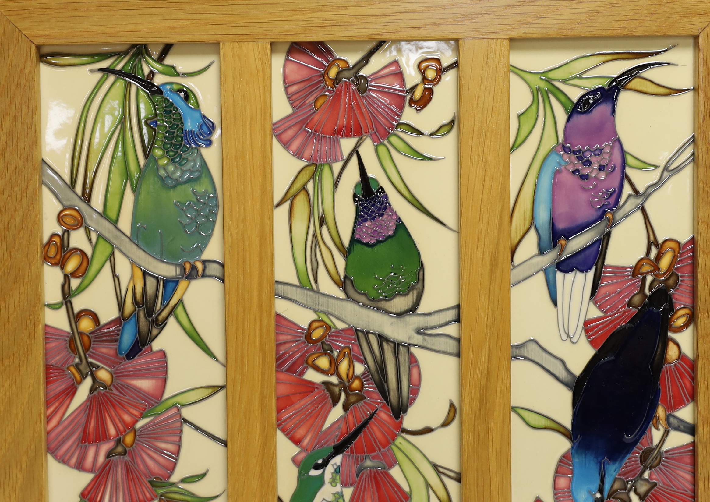 A framed Moorcroft Rachel Bishop triple wall plaque of humming birds, 36 x 38cm total